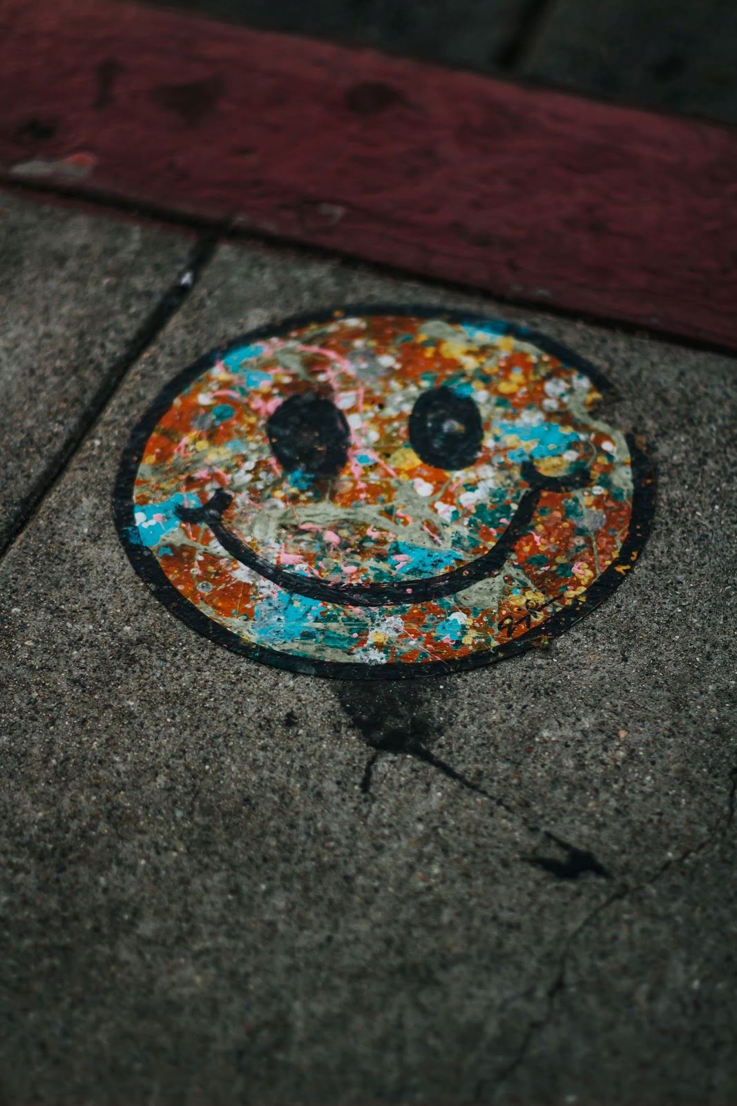 Colorful smiley on pavement