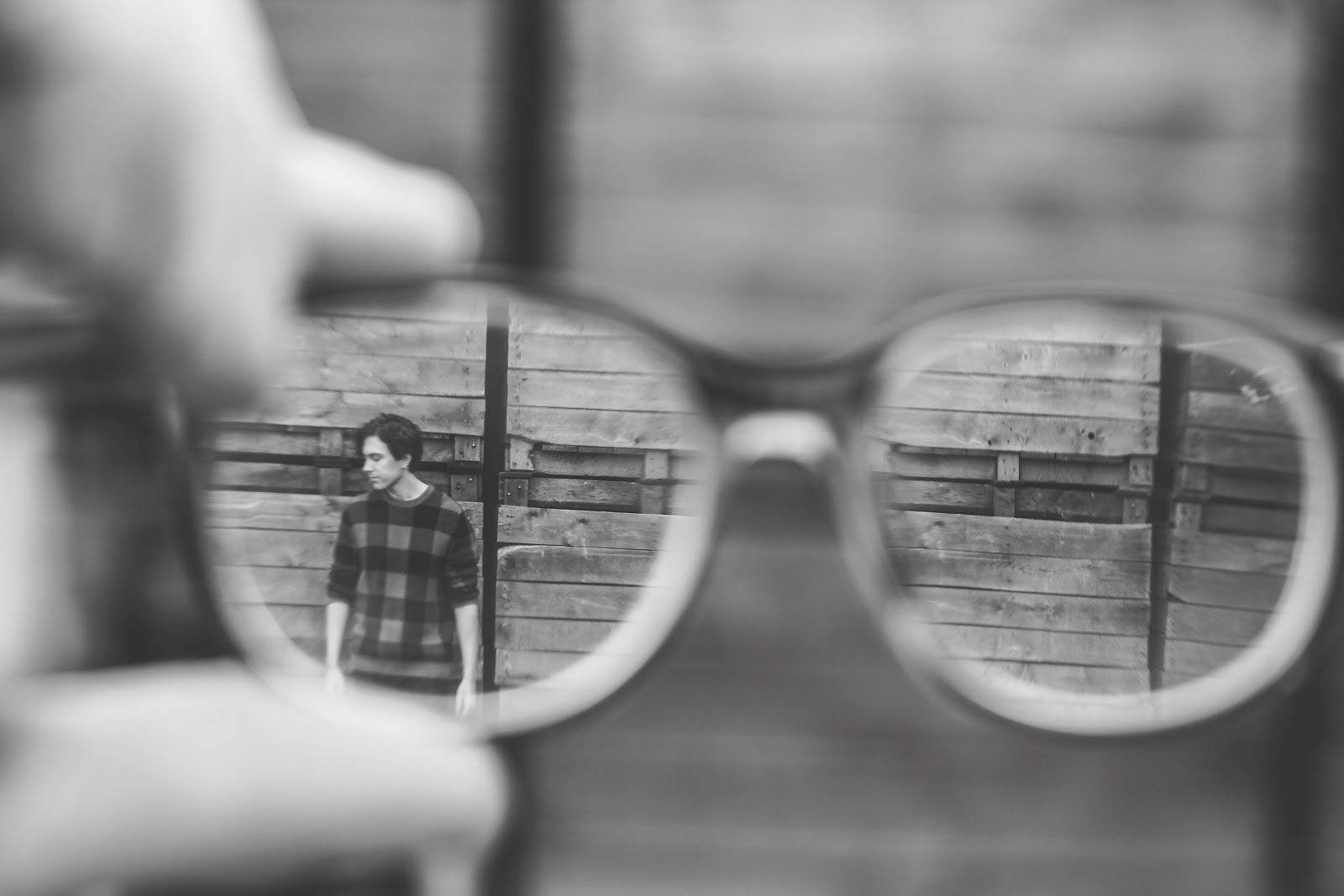 Someone looking through their glasses at someone else