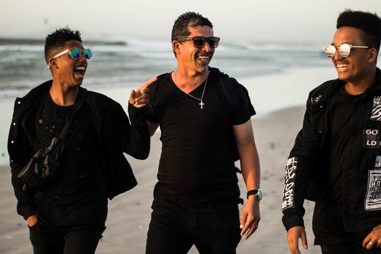 3 young lads on a beach laughing